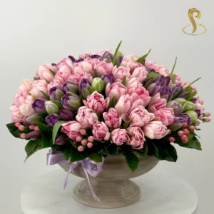 Beautiful bouquet of vibrant tulips in a sleek vase, arranged elegantly for a touch of freshness and charm, from Sweetspetals US.