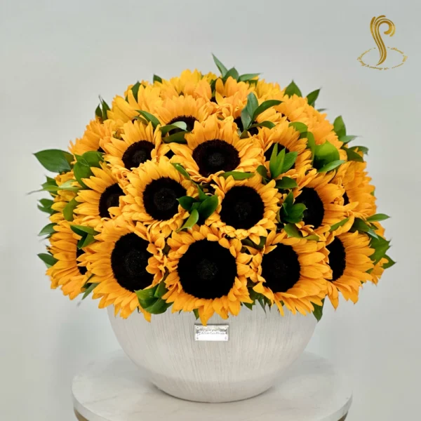 Bright and vibrant sunflowers in a stylish vase, arranged to add a cheerful touch to any space, from Sweetspetals US.