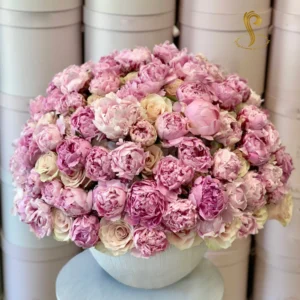 A stunning arrangement of peonies and roses from Sweetspetals US, showcasing a luxurious mix of soft, romantic blooms in vibrant colors, ideal for special occasions or home decor.