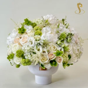 "SP Pure Grace" features an elegant bouquet of soft white lilies, delicate roses, and lush greenery, creating a serene and timeless floral arrangement. Perfect for expressing purity, grace, and sophistication.