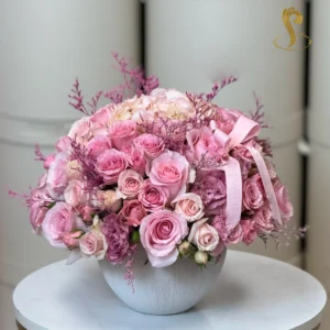 "SP Petit Pink Passion" features a delicate arrangement of soft pink roses, peonies, and lush greenery, creating a romantic and elegant bouquet perfect for expressing love and affection.